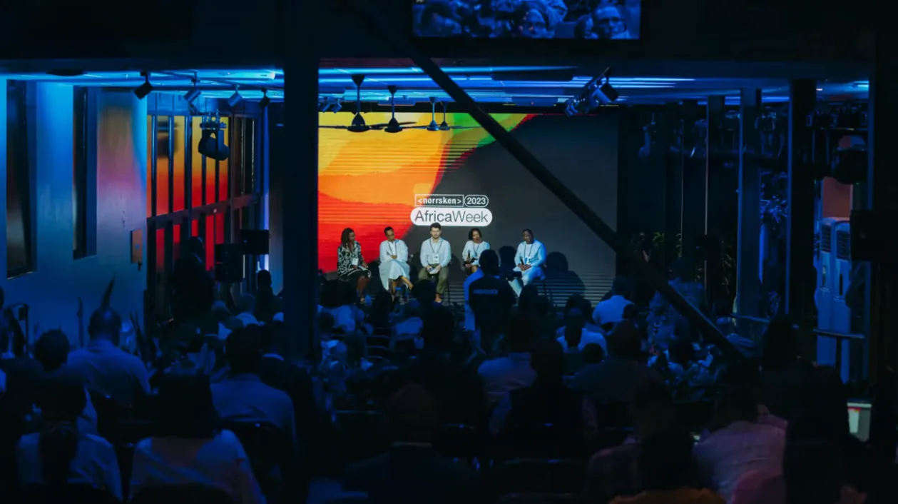 A panel on stage in a blue-lit hall at Norrsken Africa Week