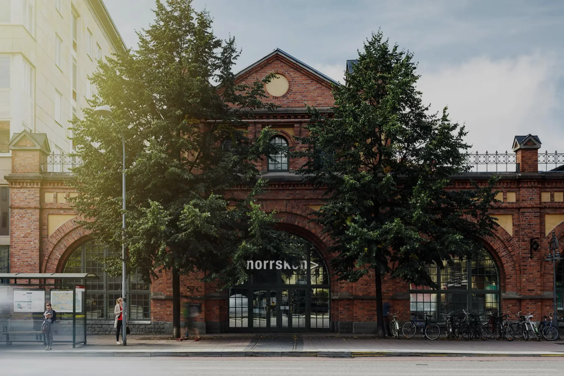 Norrsken House Stockholm, a red-brick former tram hall behind two linden trees